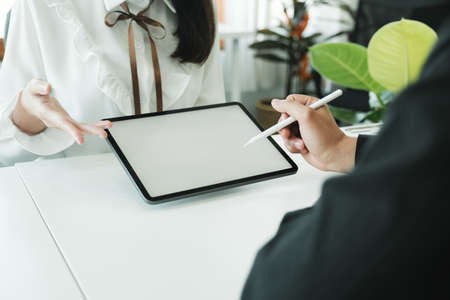 Businessman teamwork meeting and discussing on with mock-up tablet using stylus pen.