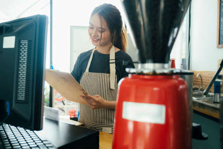 Businesswoman cafe owner smiling confident take an order.