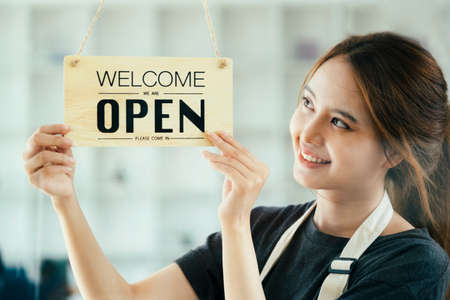Young business owner open the coffee shop.