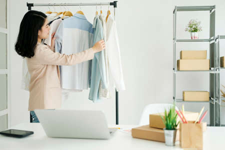 Businessowner checking clothes in small business.の写真素材