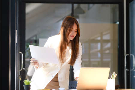 Businesswoman is working at office and using laptop.の写真素材