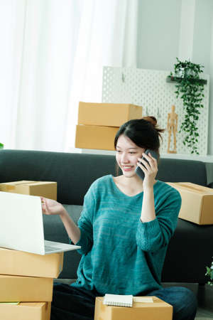 Asian business owner always keep contact with customer.の写真素材