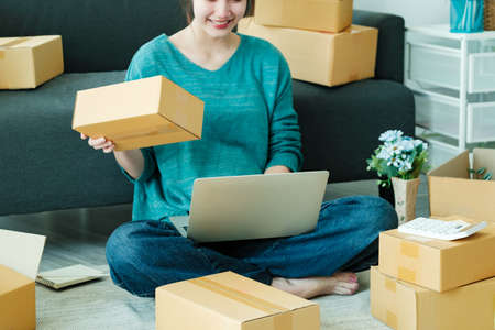 Online small business owner checking order.