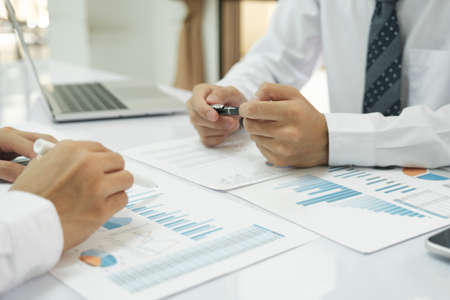 Asisan businessman teamwork meeting and discussing the investment data and report graph.