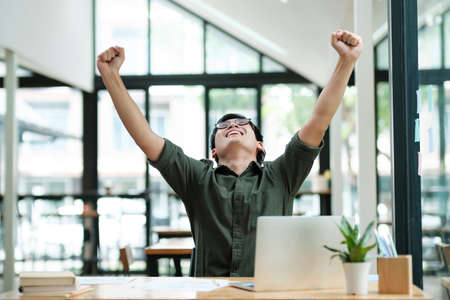 Enjoy young man celebrate success or happy pose.の写真素材