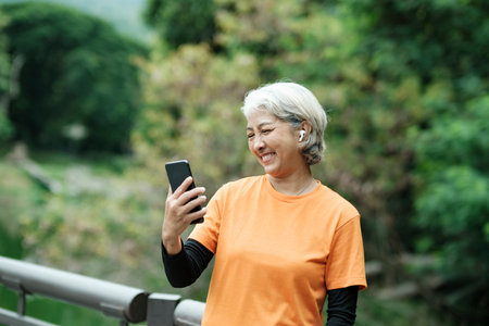 Happy senior woman taking selfie photo while before running in park. Concept of a healthy lifestyle on retirement. health concept.の写真素材