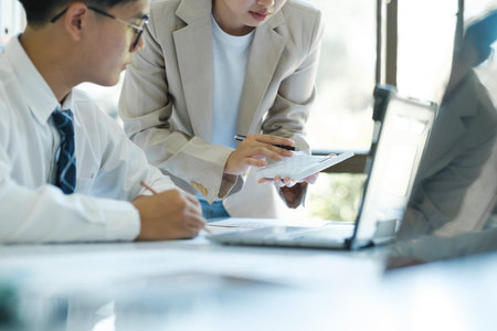 close up businesspeople or office workers are working together on investment project. They are discussing, sharing the ideas, planning, and analyzing the business strategy. And set up the budget for financial plan by using laptop and calculator.の写真素材