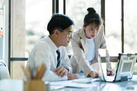 Businesspeople or colleagues are working together on investment project, discussing, sharing ideas, planning, and analyzing the business strategy and finance using laptop computer.の写真素材