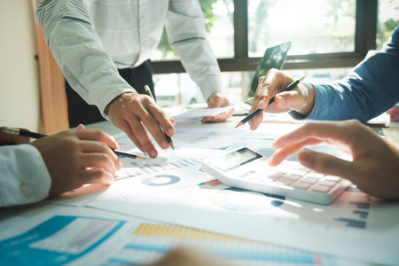 Close-up of businessmen working together at workplace, discussing about strategies, plans, analytic...