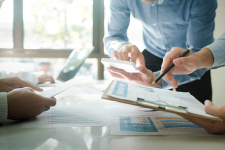 Close-up of businessmen working together at workplace, discussing about strategies, plans, analytic...