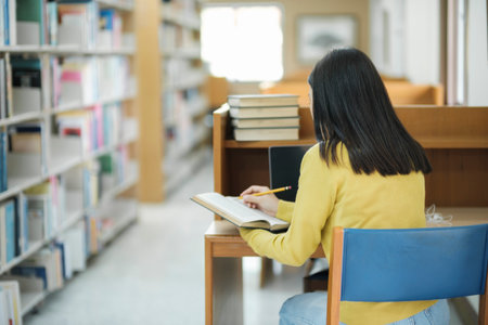 Student sitting and studying at library.の写真素材