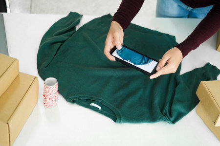 Female owner taking pictures of online product.の写真素材