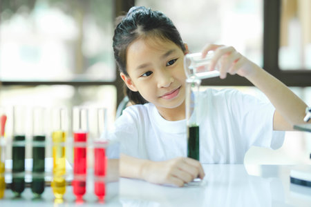 Little child with learning science class in school laboratoryの写真素材