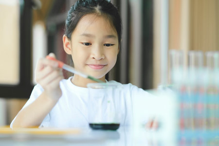 Little child with learning science class in school laboratory