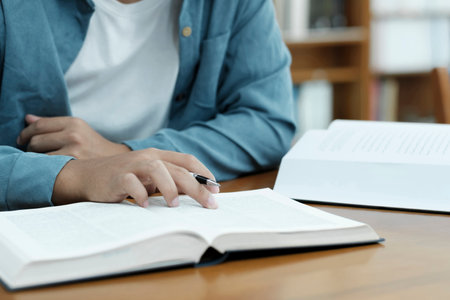 Close up hands with pen writing on notebook.の写真素材