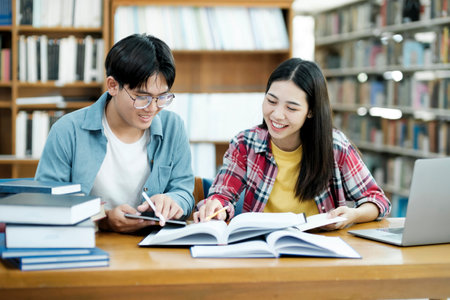 Young students campus helps friend catching up and learning.の写真素材
