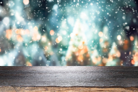 Empty wooden table for present product on christmas tree and bokeh blur background.