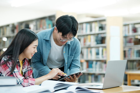 Young students campus helps friend catching up and learning.の写真素材