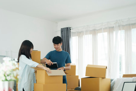 Young married couple moving into new home.の写真素材