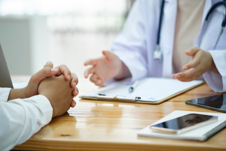 Doctor and patient. Doctor having a checkup with a patient at clinic.の写真素材