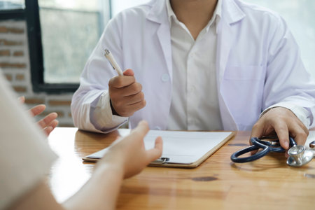 Doctor and patient. Doctor having a checkup with a patient at clinic.の写真素材