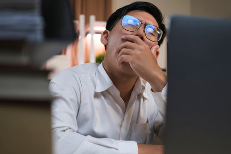 Yawn burnout and tired businessman is sleepy in the office from deadlines
