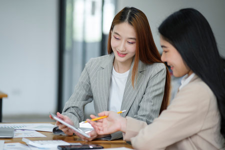 Working women are discussing work and planning new business plans exchanging ideas with colleaguesの写真素材