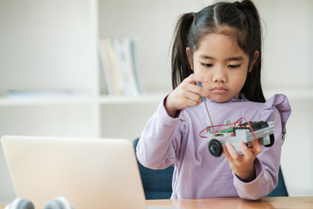 STEM education concept. Asian young girl learning robot design.