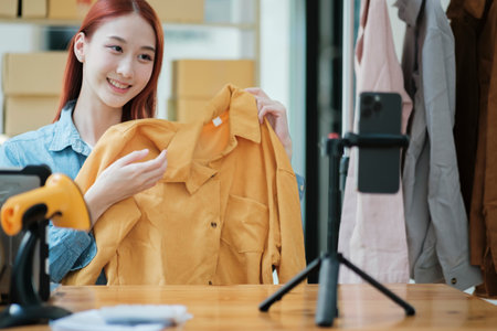 Entrepreneur Showcasing Clothes for Online Storeの写真素材