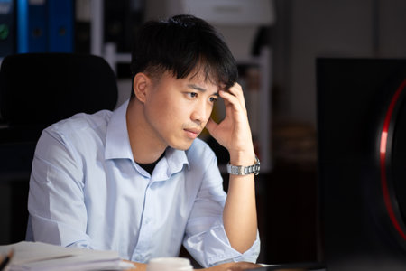 Businessman working overtime at his office He felt tired.の写真素材