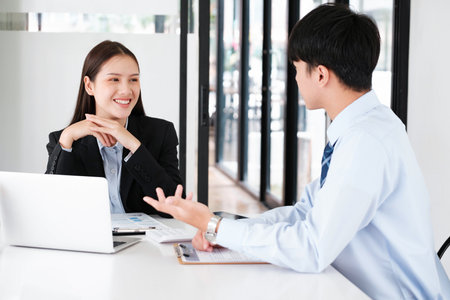 A candidate engaged in a job interview with a hiring manager, discussing qualifications and employment opportunities.の写真素材