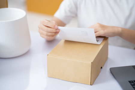 The business of shopping online. Attaching Shipping Label to a Parcel.