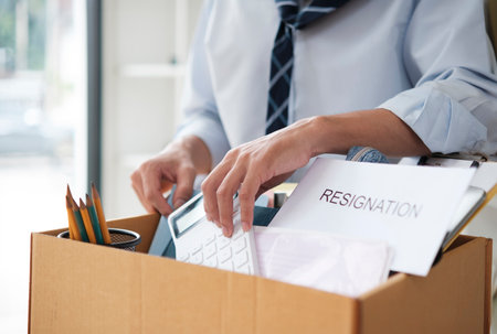 Businessman Packing Personal Belongings in Office After Resignation or Job Lossの写真素材