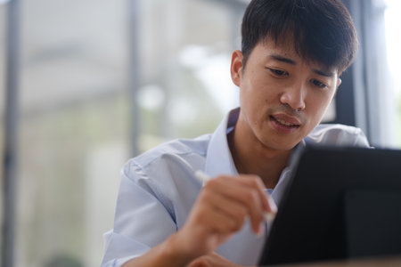 Business consultant analyzing financial data on a laptopの写真素材