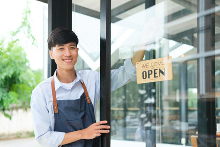 Small business owner opening shop to welcome customers