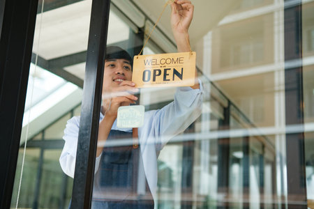 Small business owner opening shop to welcome customers