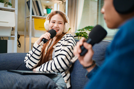 Podcast conversation between young man and woman with headphones and microphones