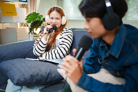 Podcast conversation between young man and woman with headphones and microphones
