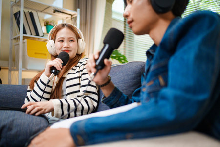 Podcast conversation between young man and woman with headphones and microphones