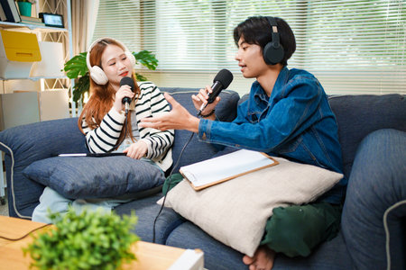 Podcast conversation between young man and woman with headphones and microphones