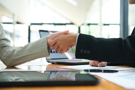 Partnership, teamwork and shaking hands for agreement, consulting or introduction in meetingの写真素材