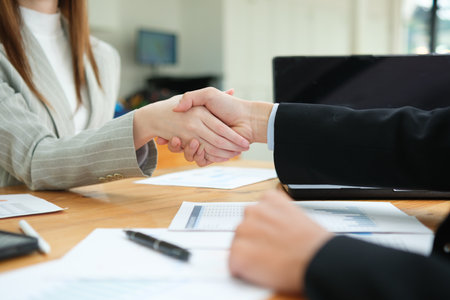 Partnership, teamwork and shaking hands for agreement, consulting or introduction in meetingの写真素材