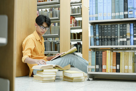 Student Of University Choosing Book and Reading Book In Library.の写真素材