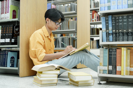 Student Of University Choosing Book and Reading Book In Library.の写真素材