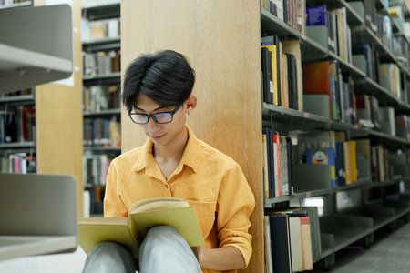 Student Of University Choosing Book and Reading Book In Library.の写真素材