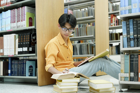 Student Of University Choosing Book and Reading Book In Library.の写真素材
