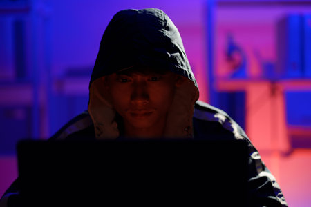 Hacker launching cyberattack targeting data systems and exposing cybersecurity vulnerabilities