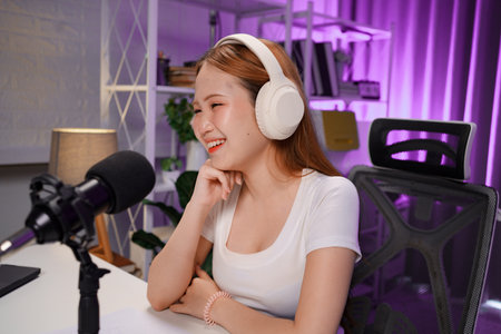 Podcast host recording professional audio for streaming broadcast and digital content creation in...