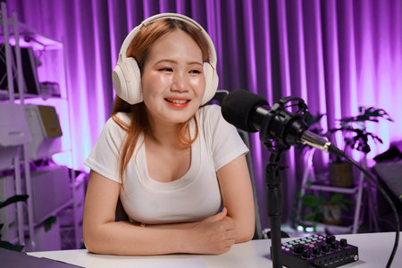 Podcast host recording professional audio for streaming broadcast and digital content creation in...