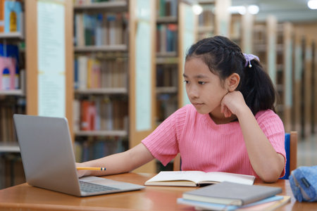 Student learning online class by using laptop computer and writing notebook at workplace, E learning and online working concept.の写真素材